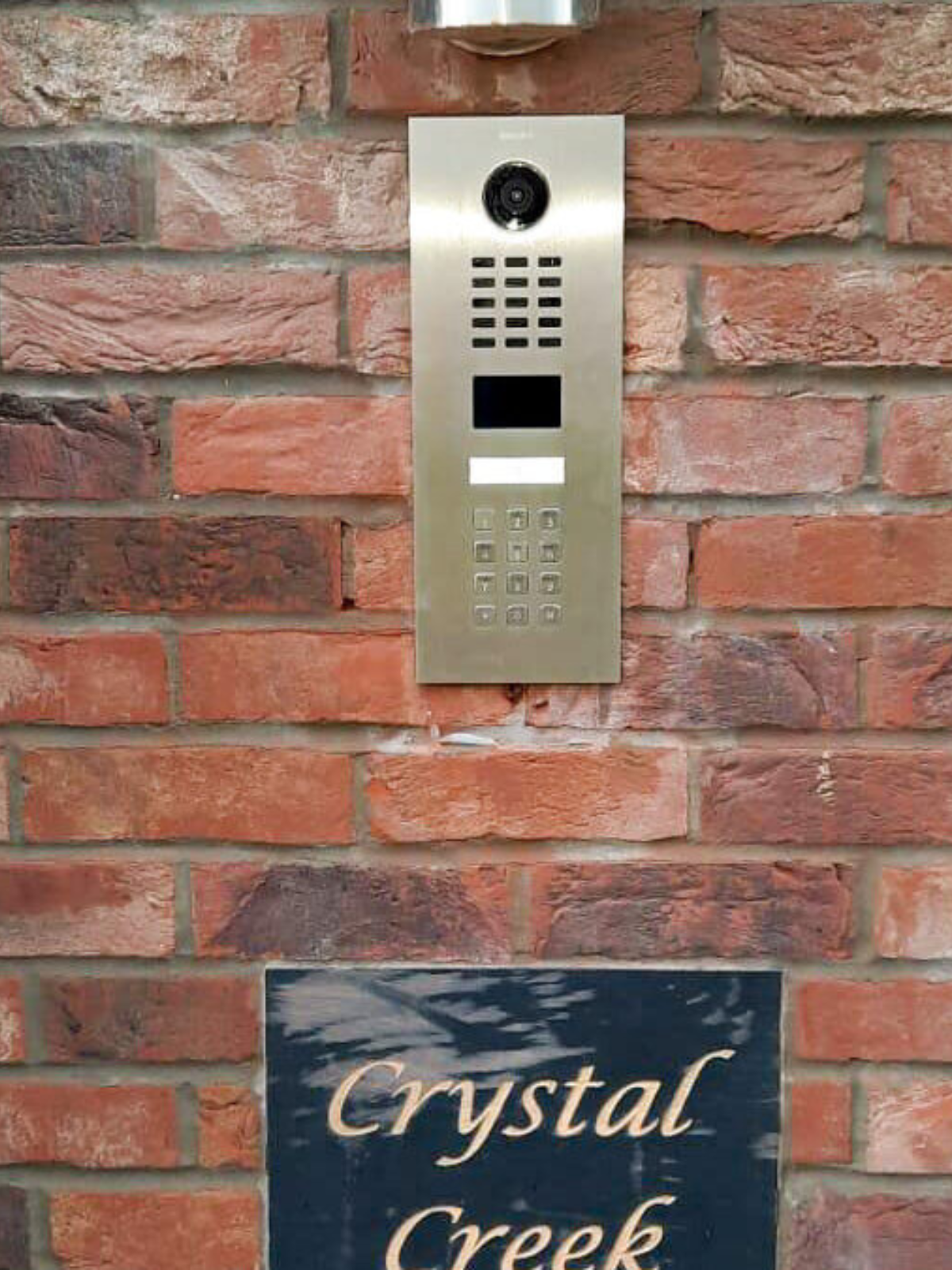 Flush mounted Doorbird Door Station on a brick wall
