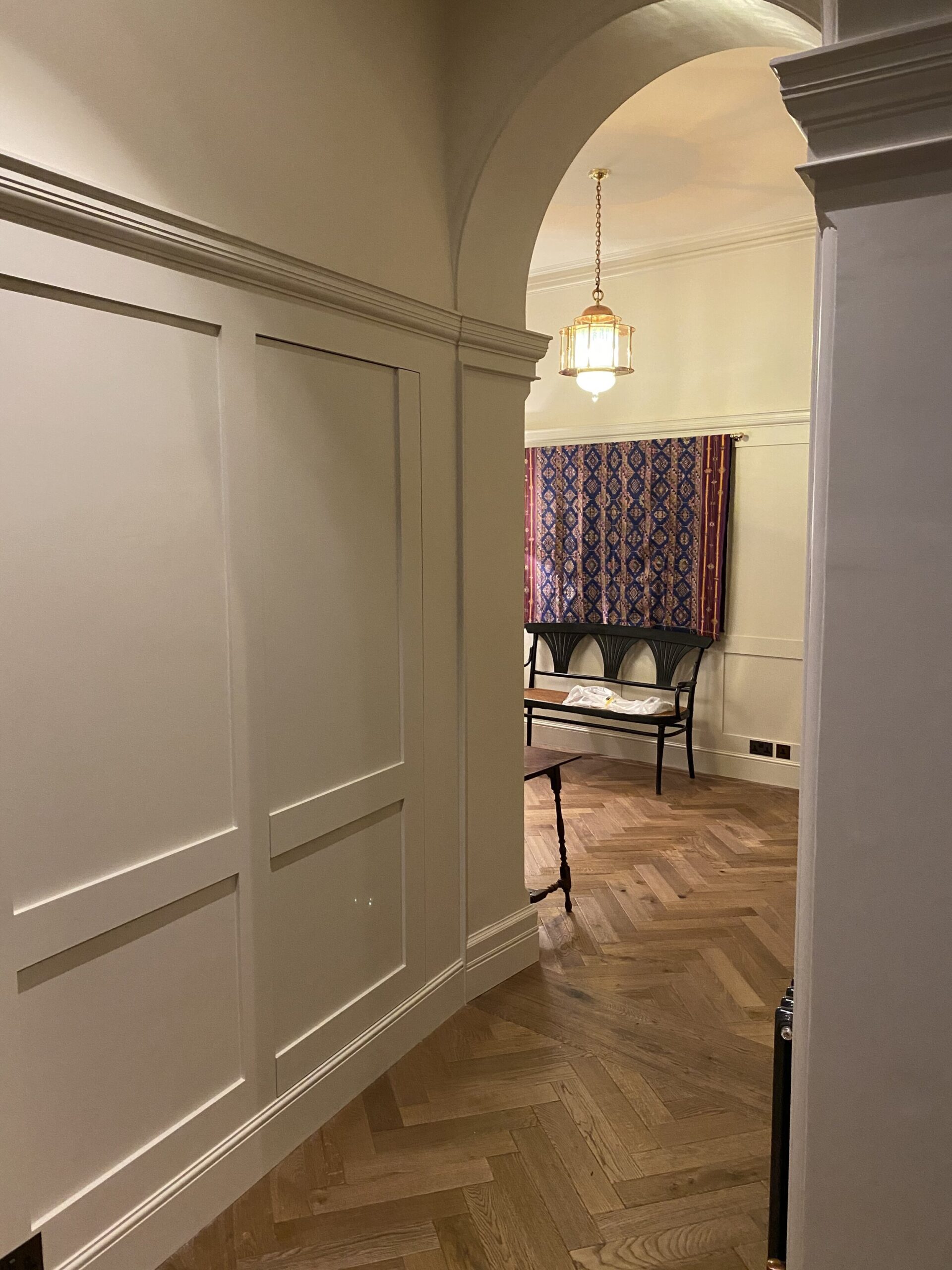 Hallway with hardwood floors and wood panelling