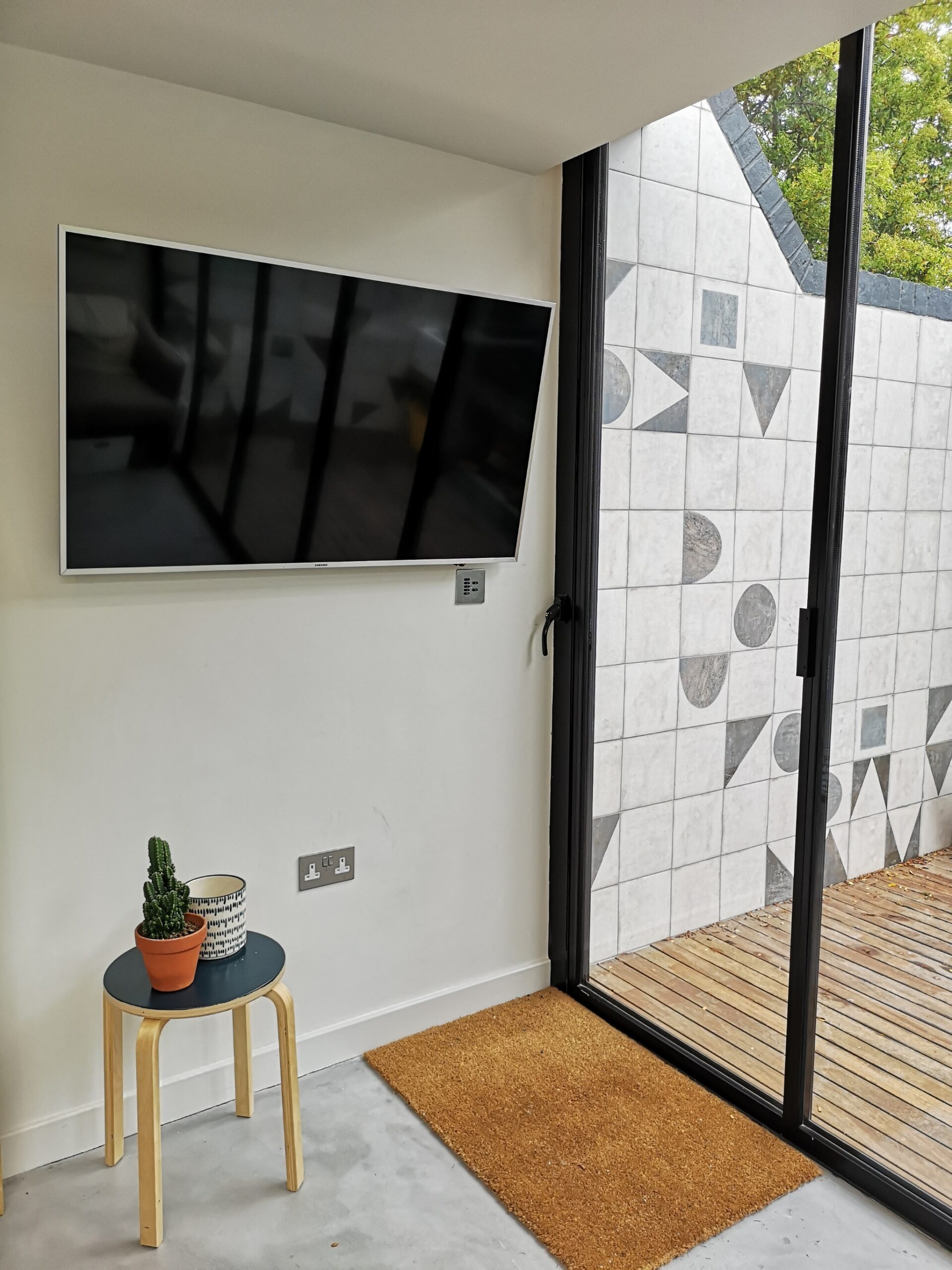 Wall mounted TV with Rako keypad underneath