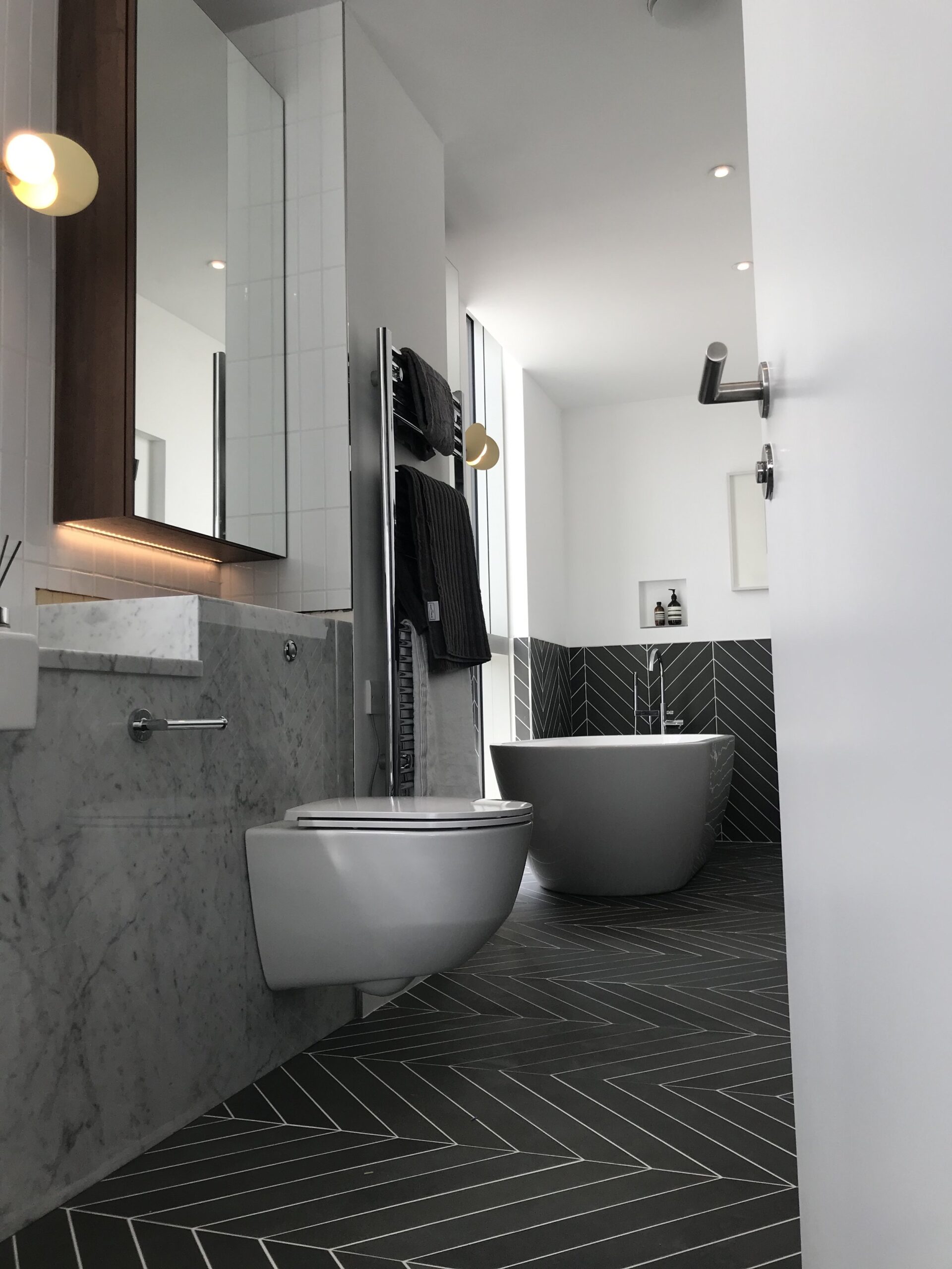 Low angle of bathroom showing toilet and freestanding bath