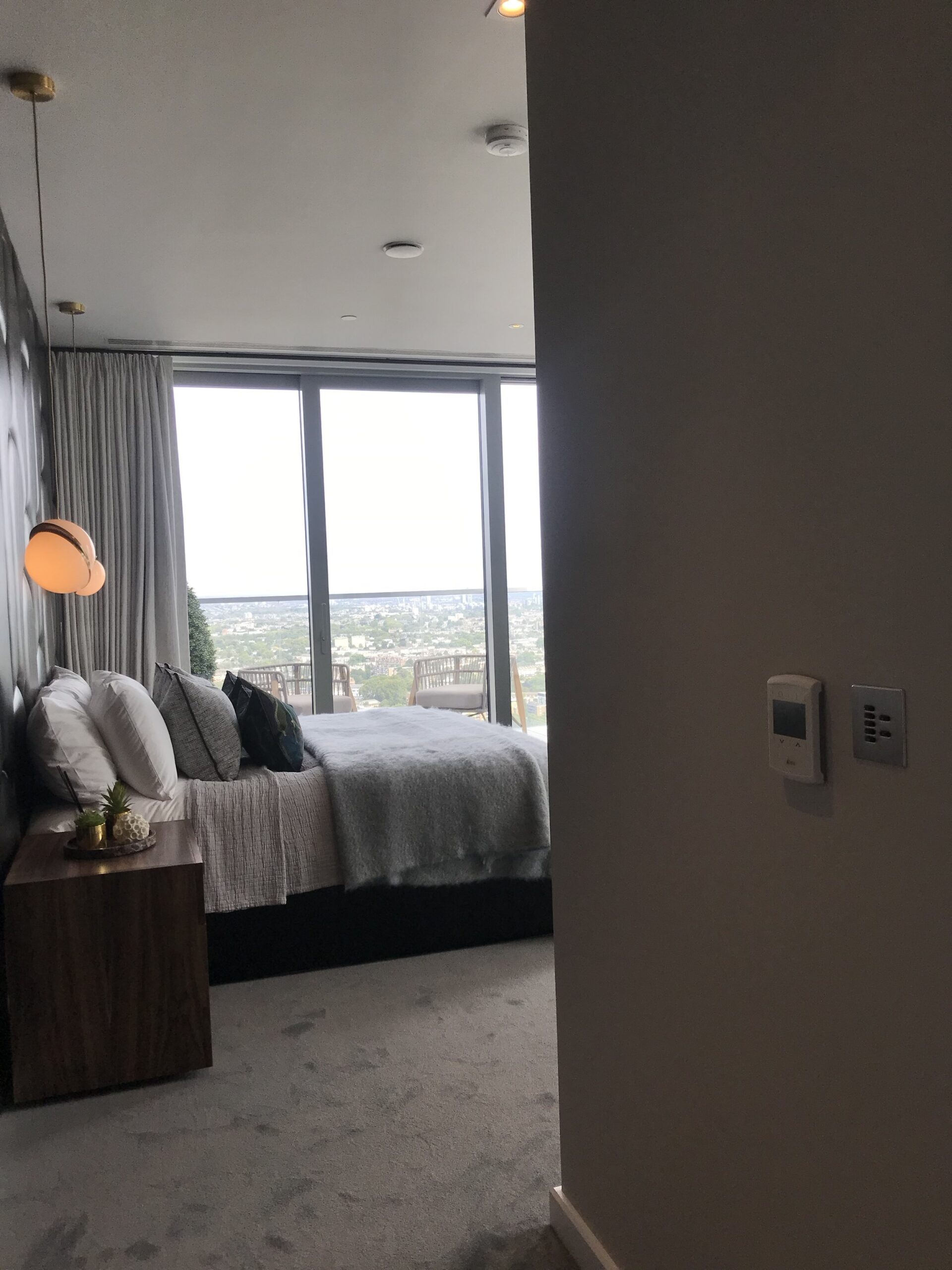 Bedroom with Rako keypad and Heatmiser panel on the wall