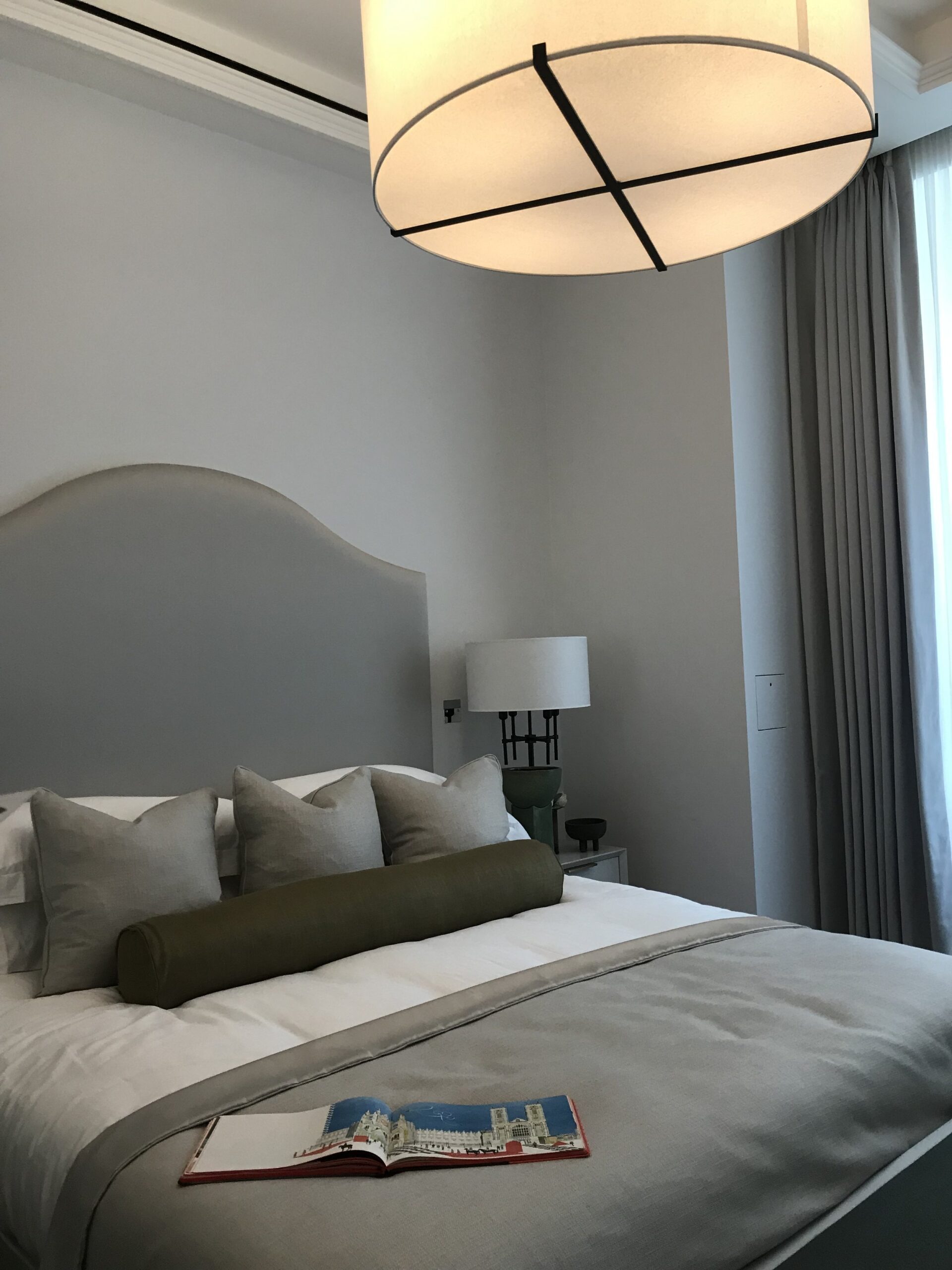 Shot of bedroom with large pendant light over the bed