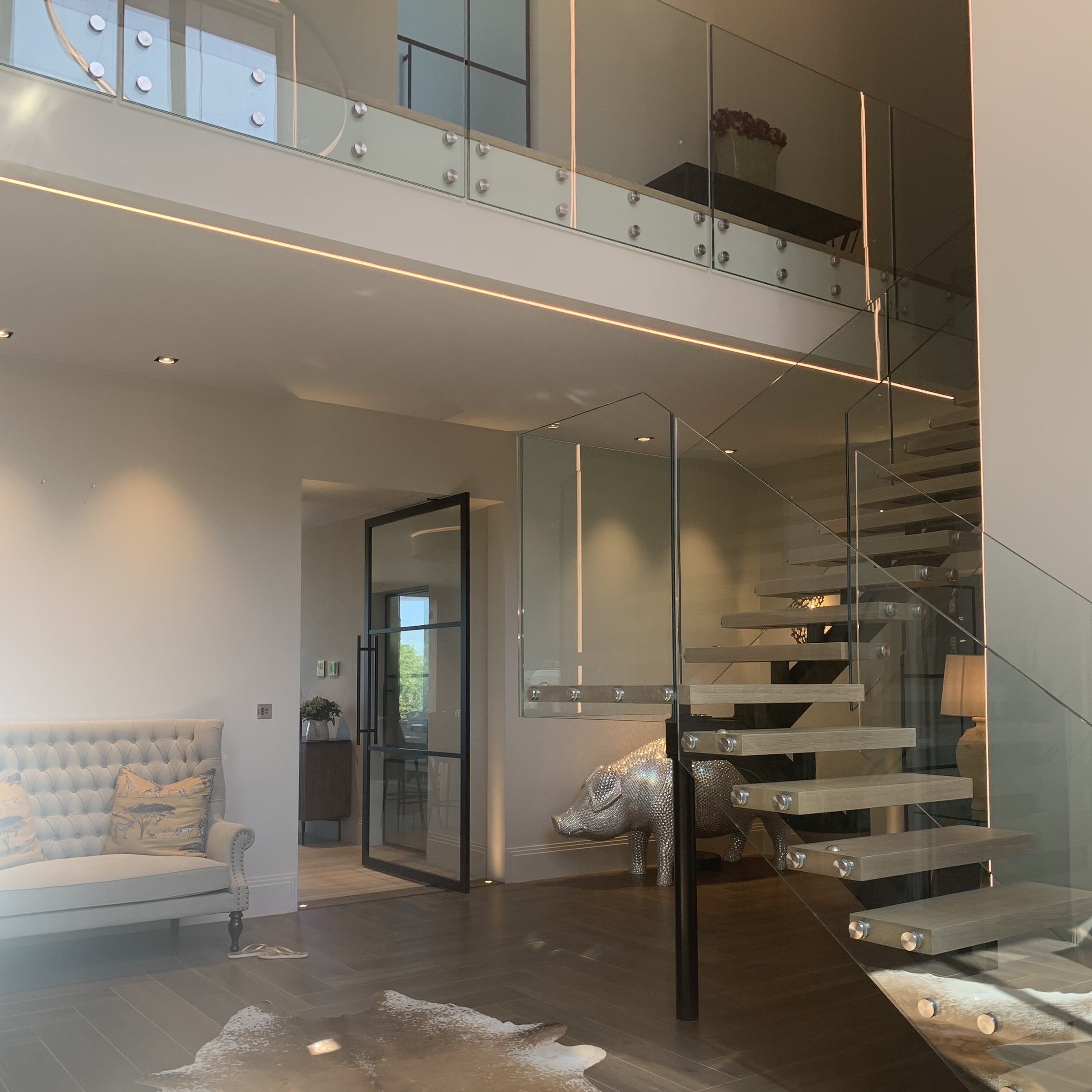 Interior of modern property in Suffolk with glass stairs