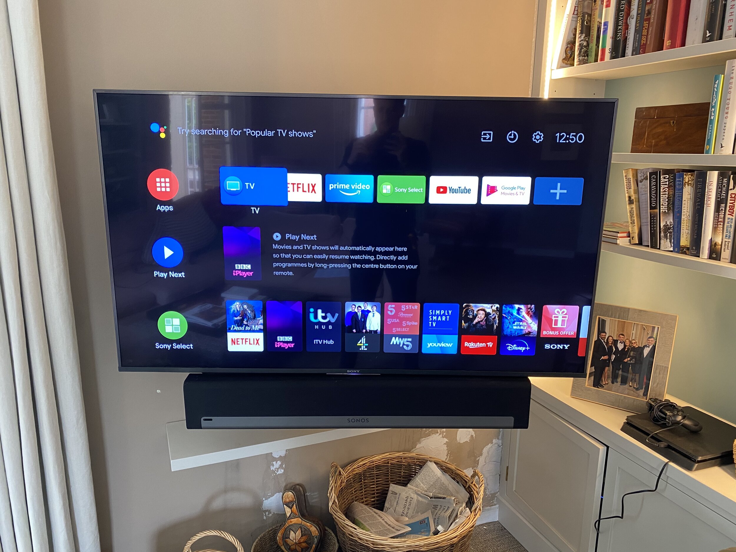Smart OLED TV with Sonos Beam in the corner of a living room
