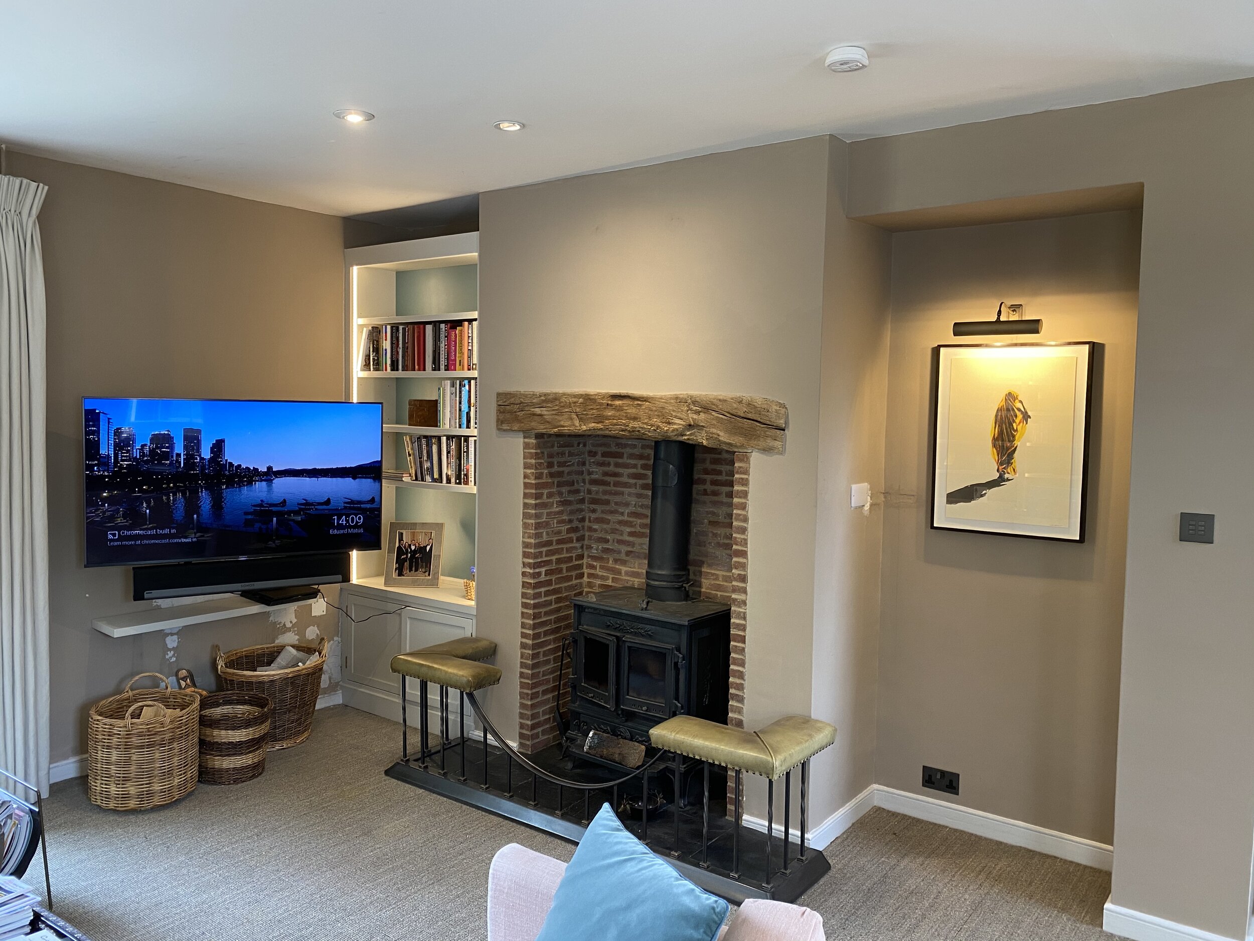 Interior of a living room with OLED television in the corner of the room and Rako light switch mounted to the wall