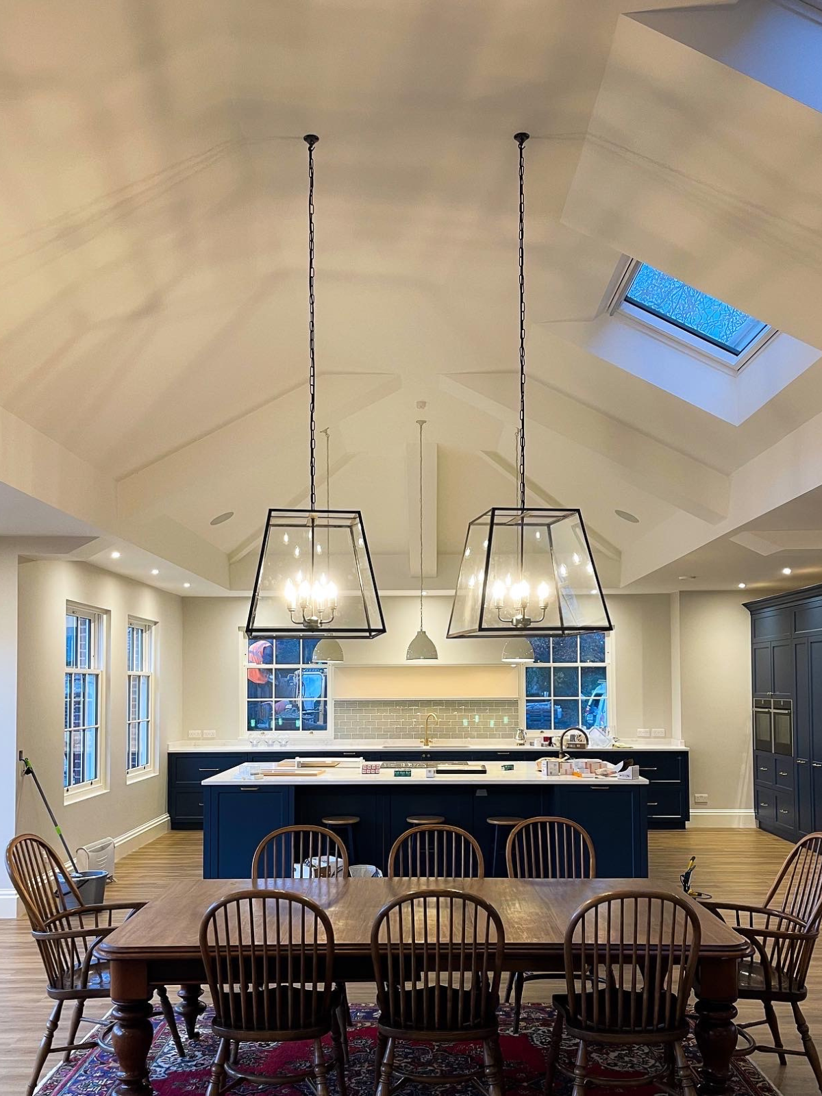 Kitchen and dining room with pendant lighting, dining room table and in-ceiling speakers