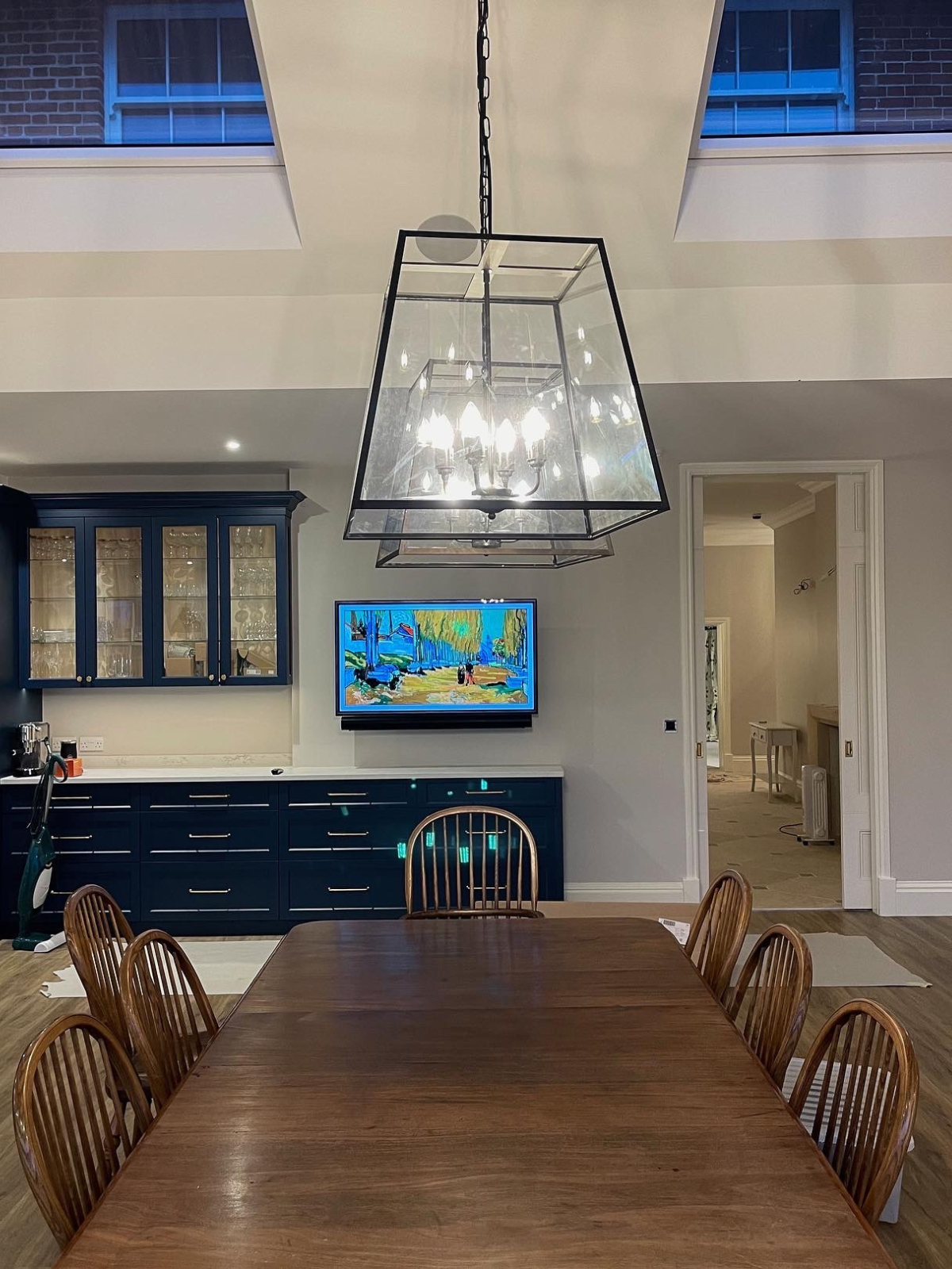 Dining room table with pendant lighting and in-ceiling speakers