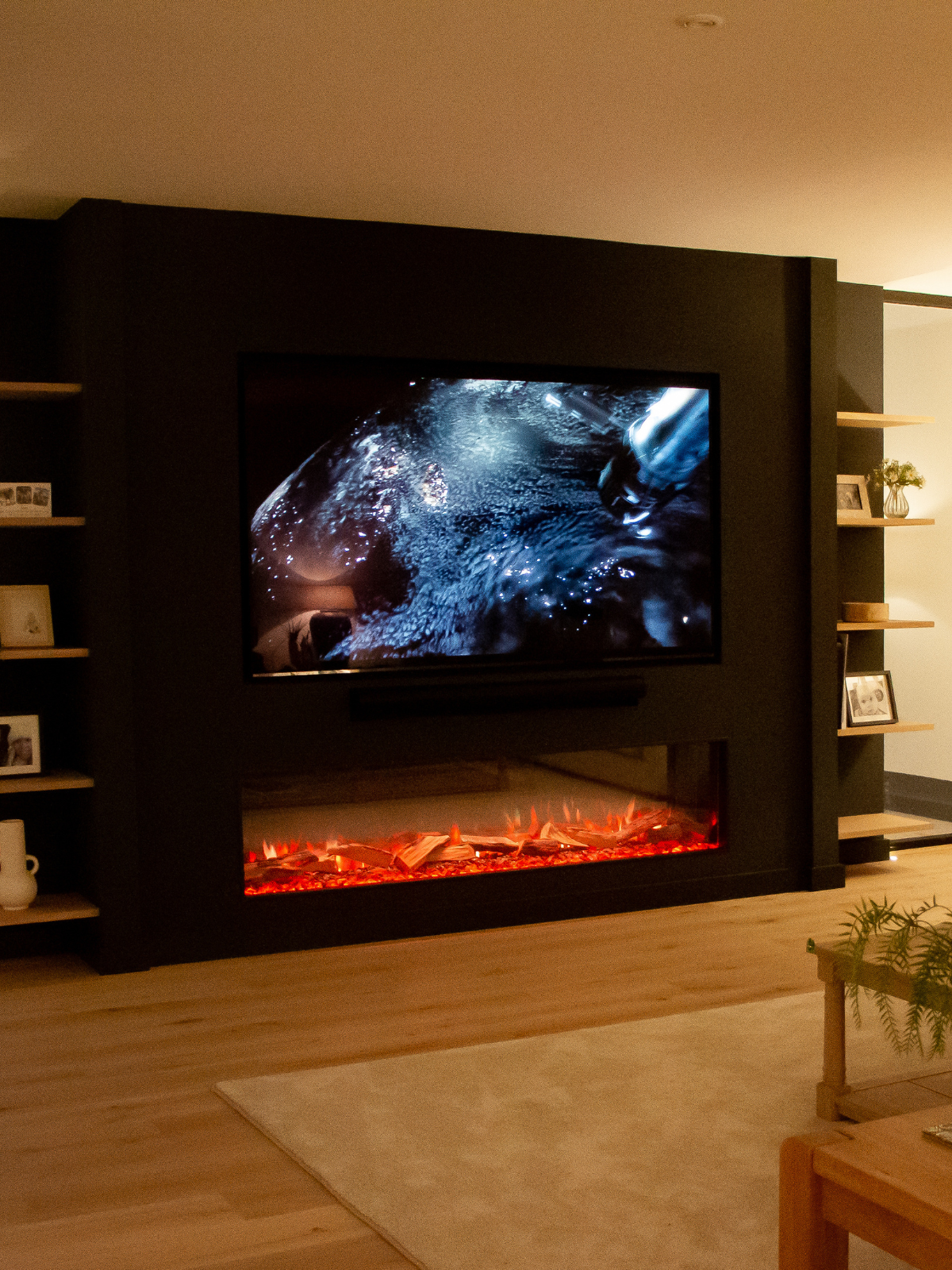Suffolk home interior in the media room with flush mounted Smart TV and soundbar above an electric fireplace