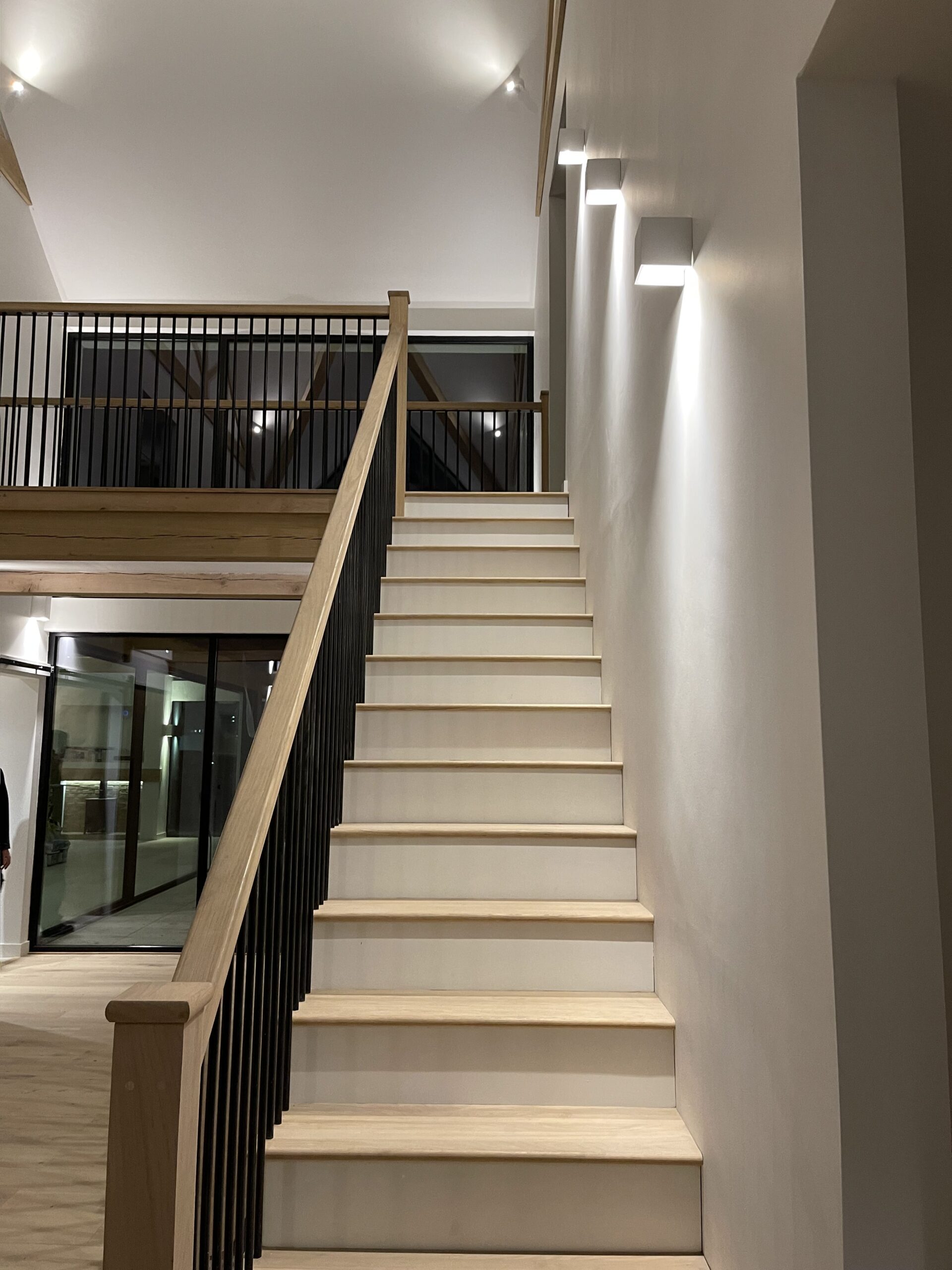 Suffolk home interior in the hallway with lighting up the side of the staircase and full length glass windows